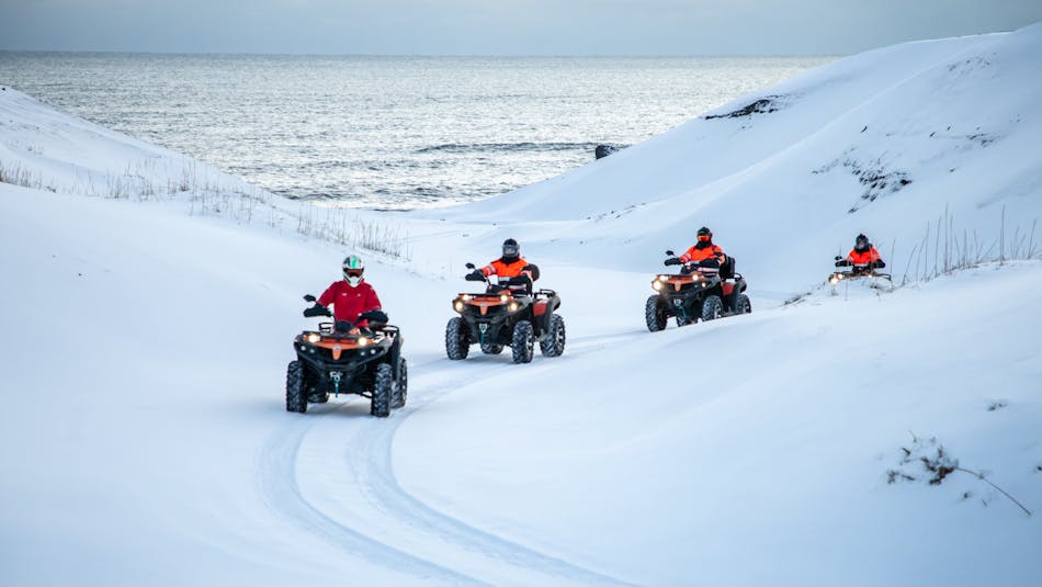 People riding quad bikes in Iceland in winter