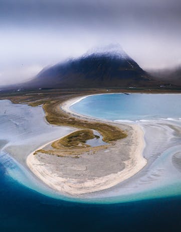 A round-shaped sand reef extending into the ocean