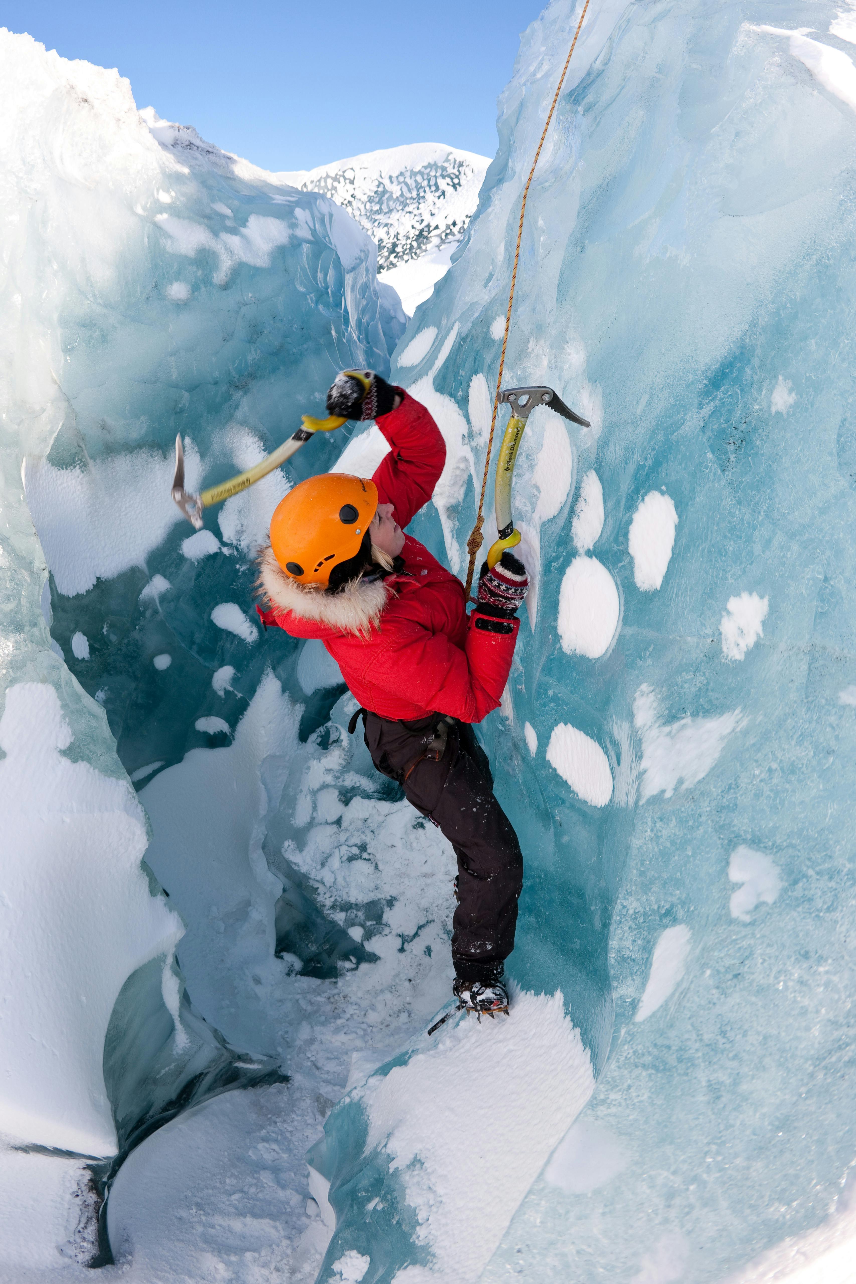 A woman ice climbing