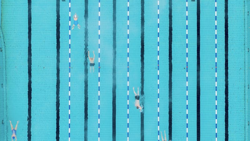 People swimming in a swimming pool as seen from above