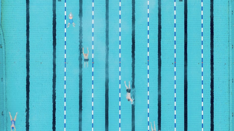 People swimming in a swimming pool as seen from above