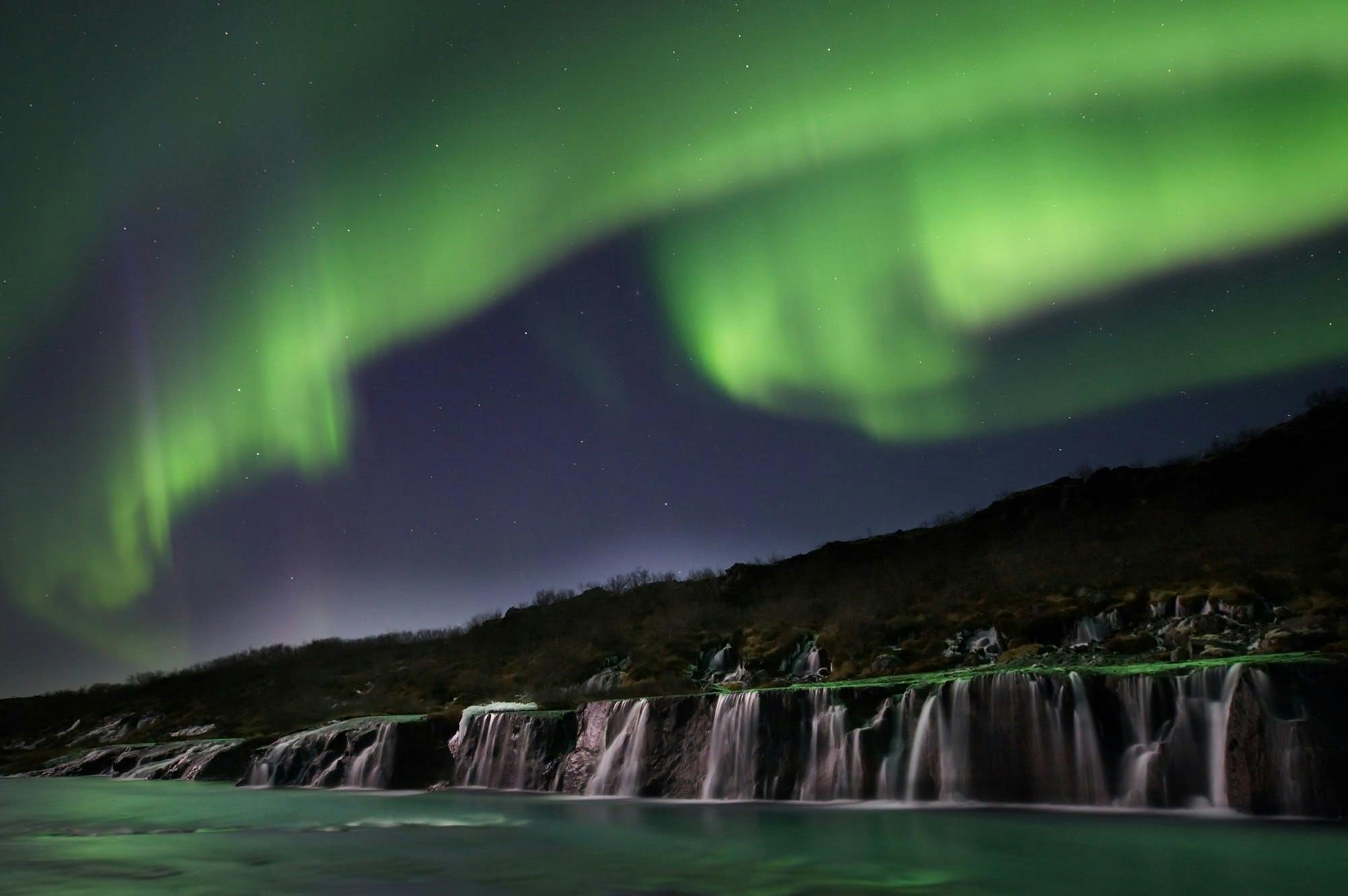 Northern lights over Hraunfossar waterfalls