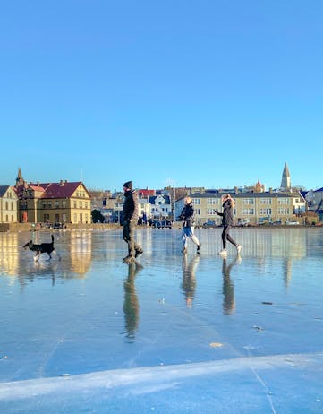 People walking on Reykjavik pond in winter