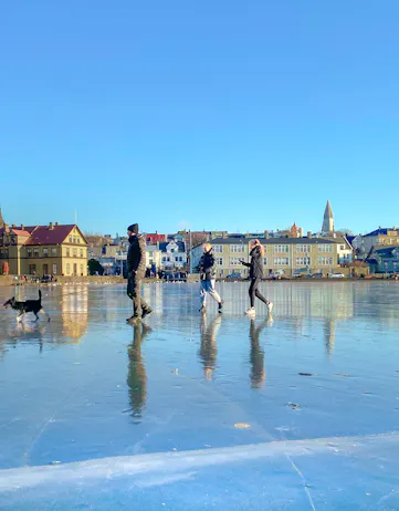 People walking on Reykjavik's frozen pond in winter
