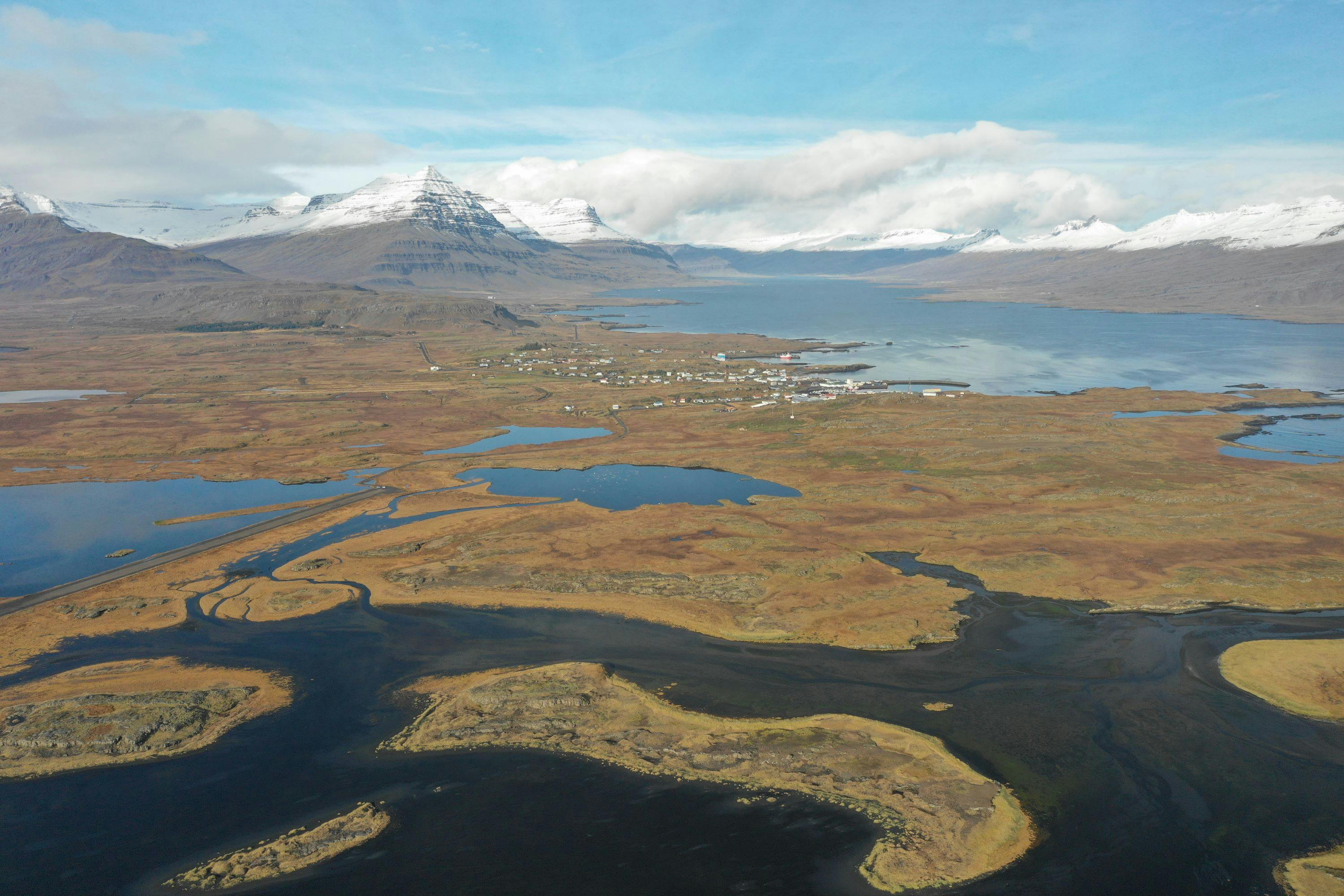 Overlooking Djupivogur town and the Berufjordur fjord, enveloped by snow-capped mountains