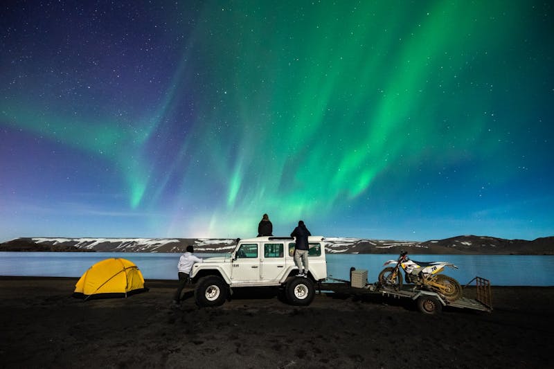 Tent, Jeep and Motorbike under the Northern Lights