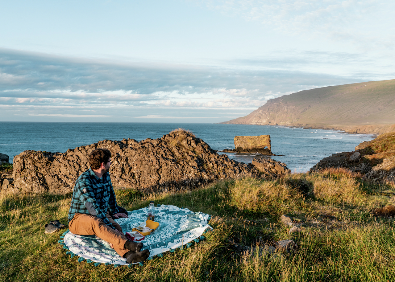 A man having a picnic on the coast of Vopnafjörður
