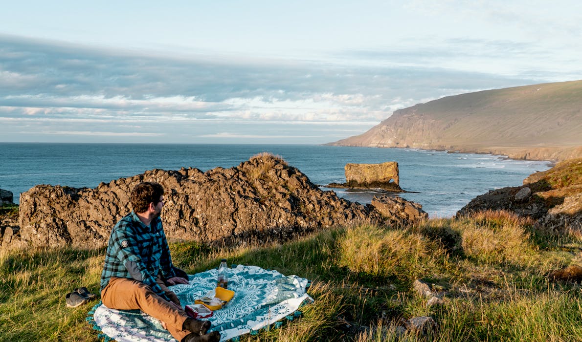 A man having a picnic on the coast of Vopnafjörður
