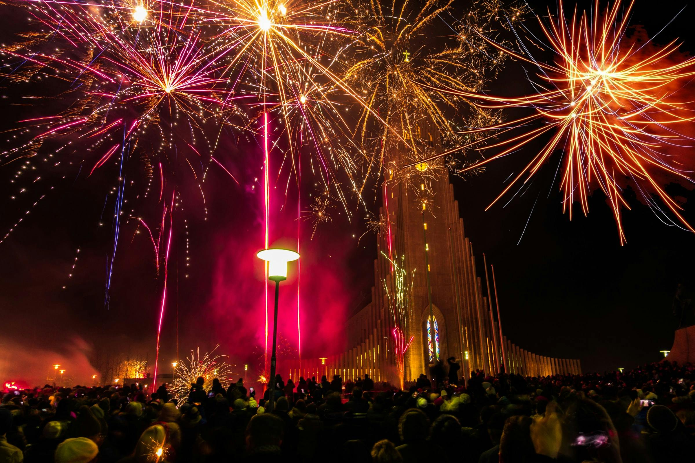 Fireworks in front of the tall Hallgrimskirkja church tower