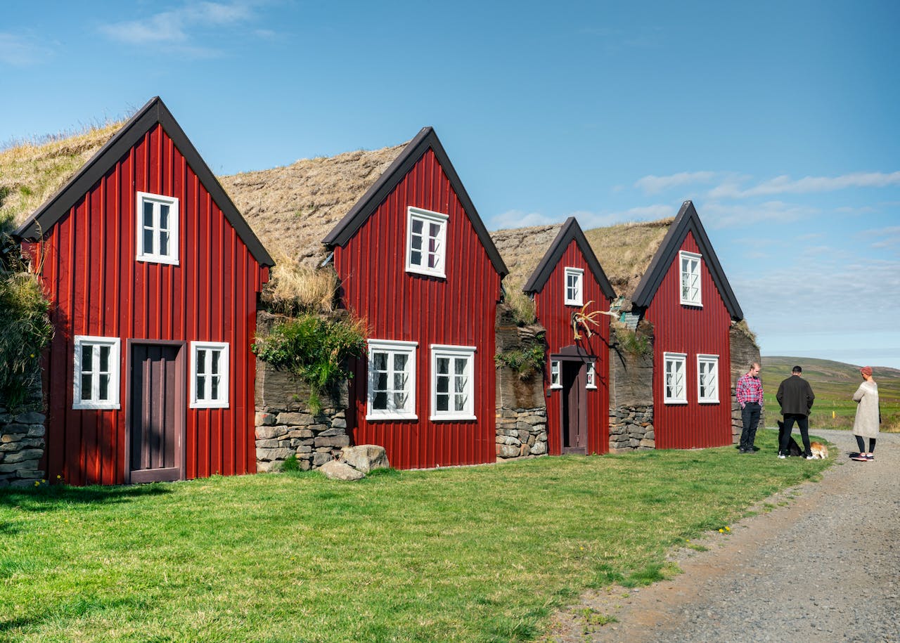 People in front of an old style farm house Burstafell in Vopnafjörður Iceland.