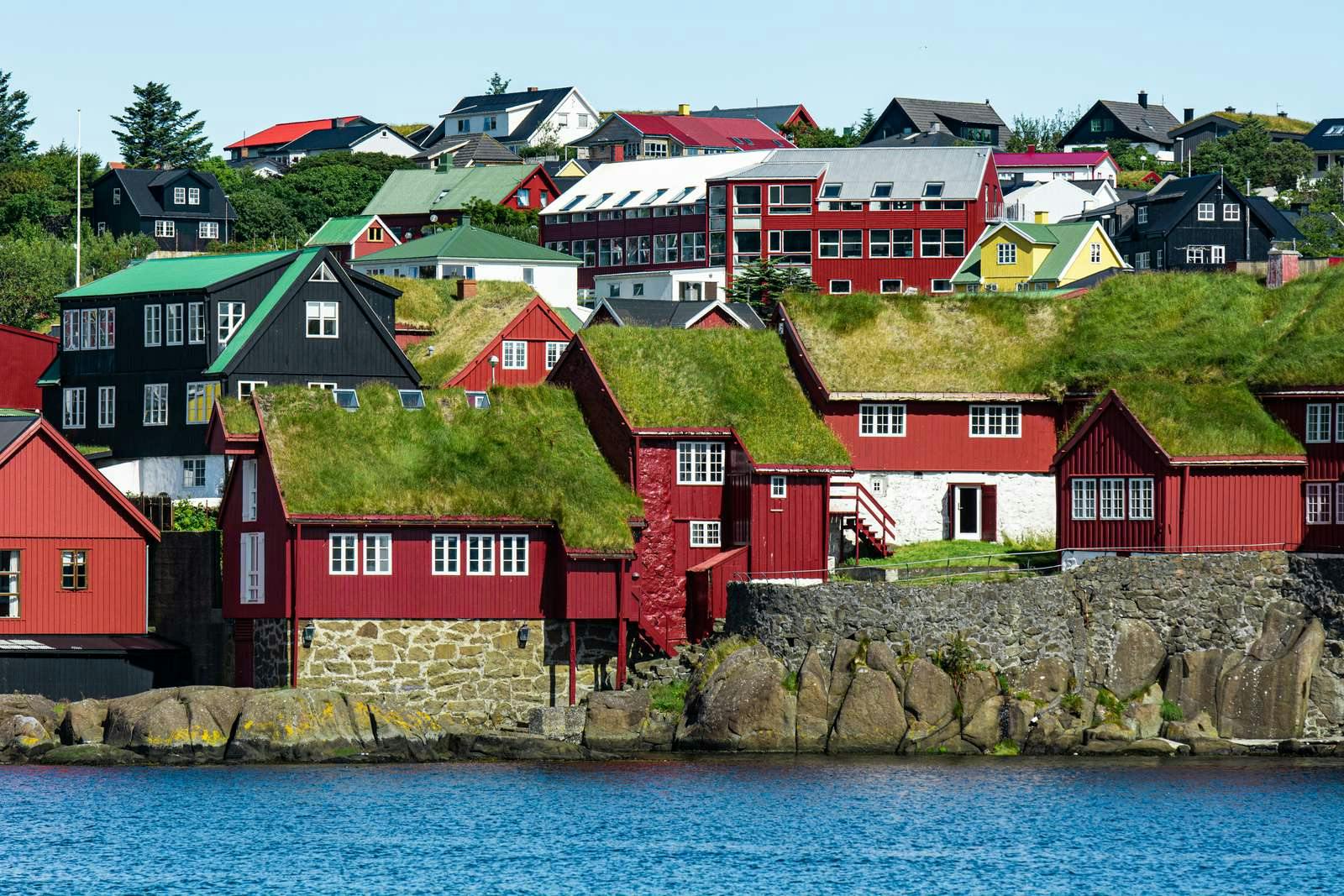 Red houses with grass roofs on the waterside in Thorshavn in the Faroe islands