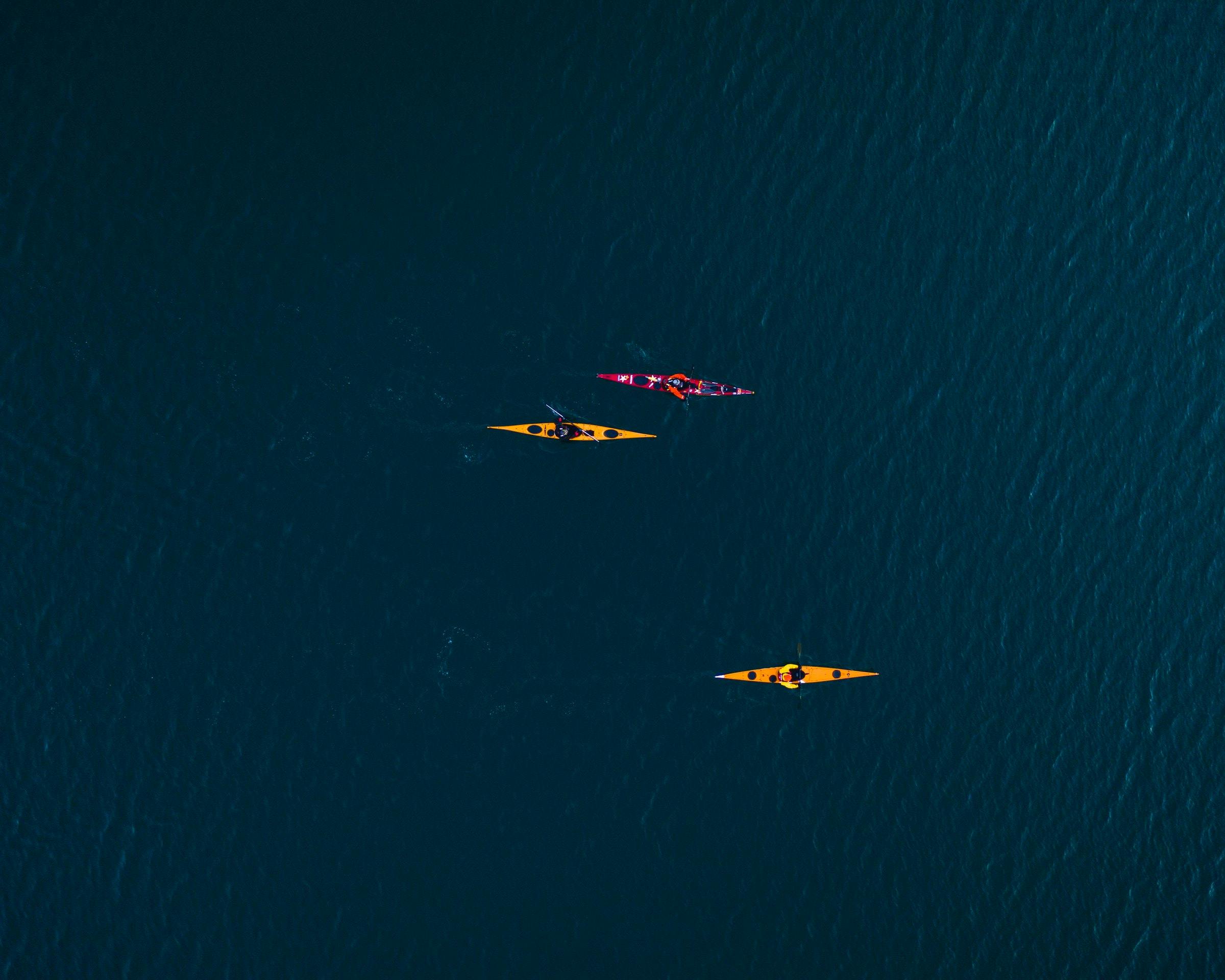 three kayaks on the ocean