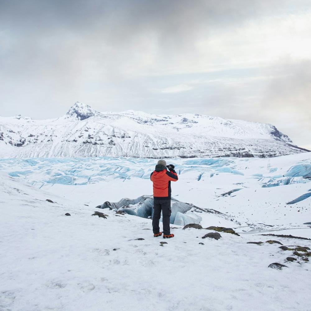 A man on filming on a glacier