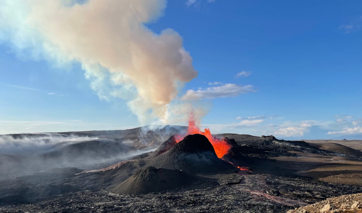 Erupting crater of Fagradalsfjall volcano producing lava and gas plume