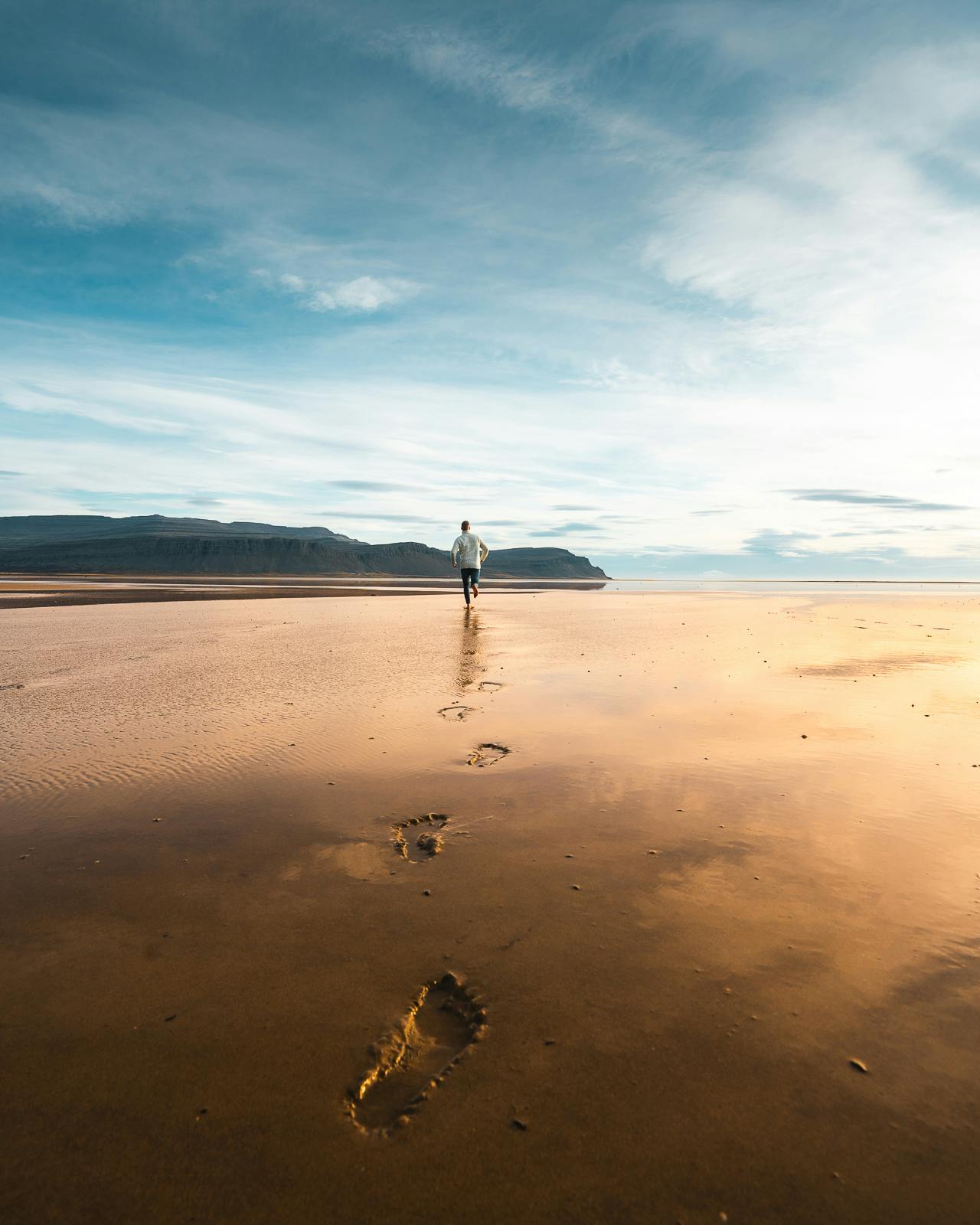 Man walking on Raudasandur beach