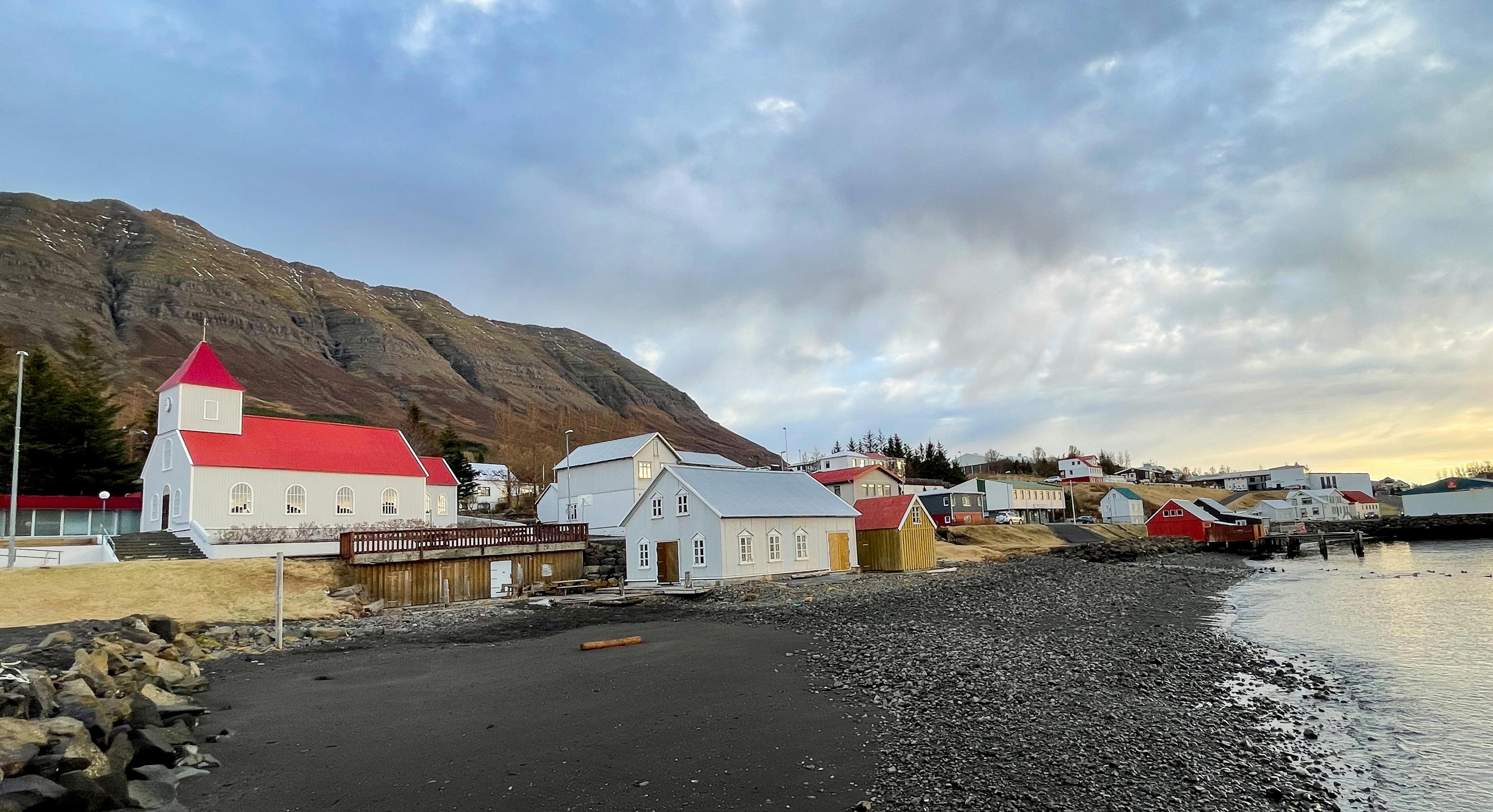 A church and wooden houses on a shore