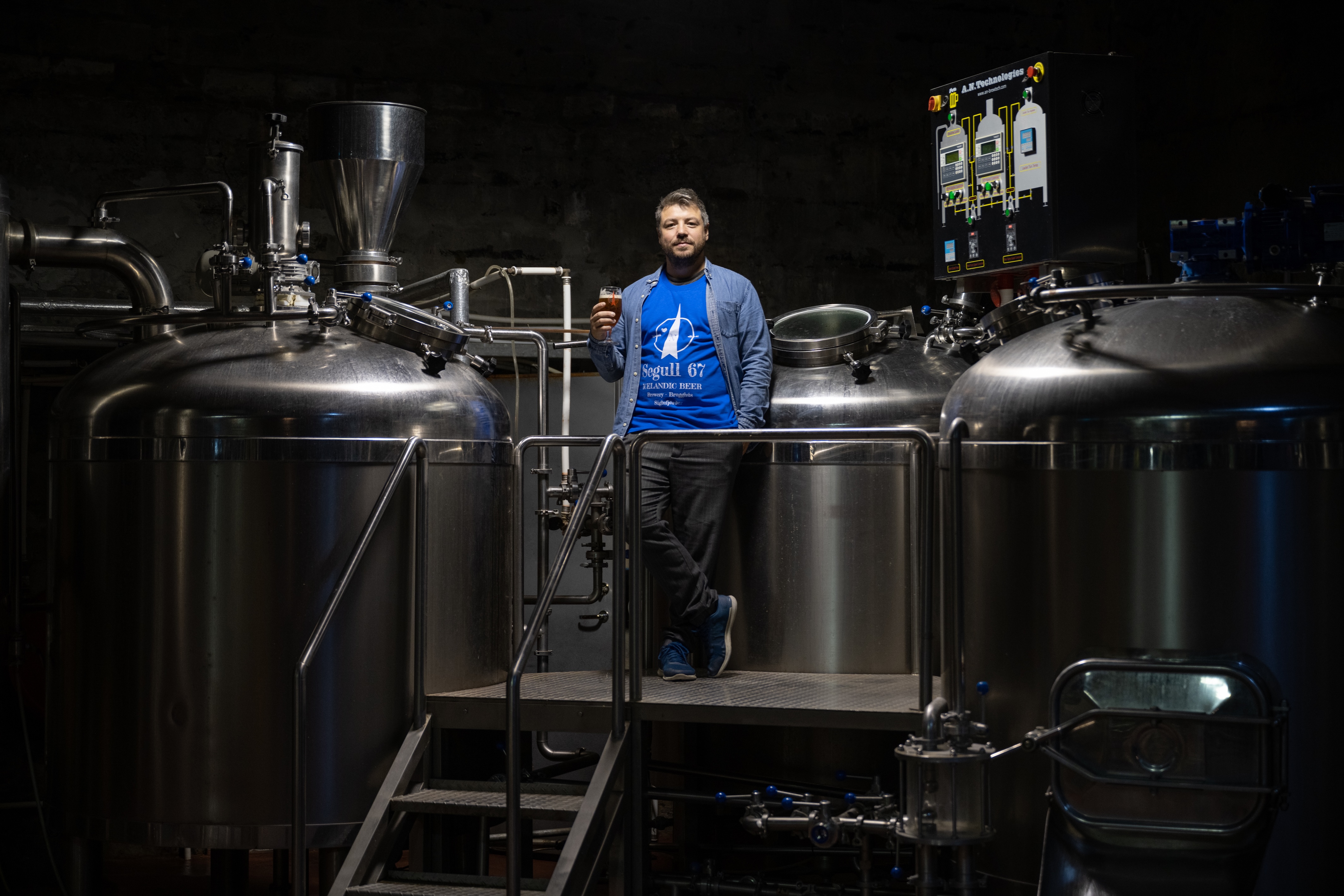 Marteinn B. Haraldsson, owner of Segull 67, stands in front of brewing vats in Iceland. Photo: Joe Shutter