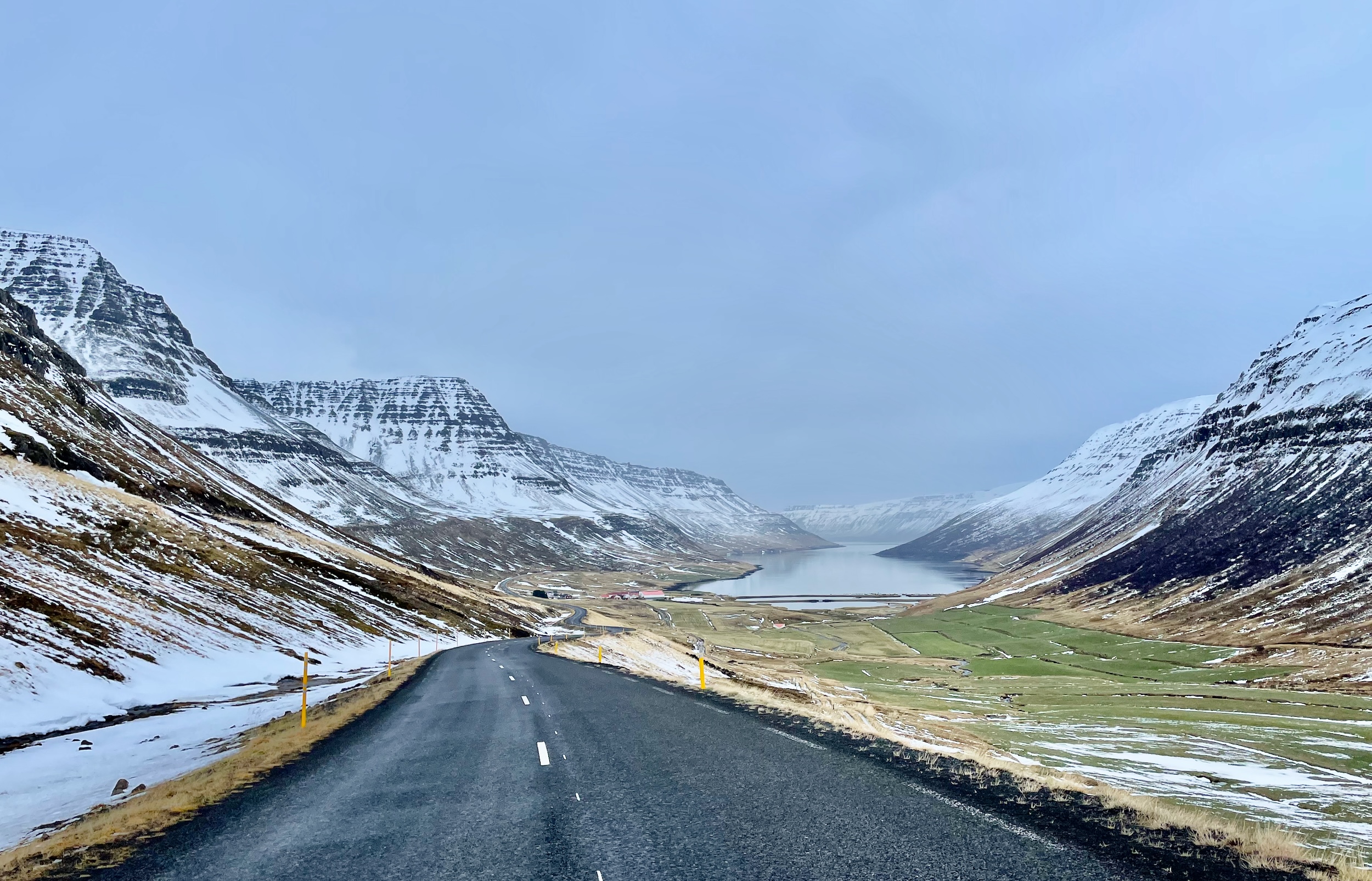 A narrow fjord with snow-capped mountains