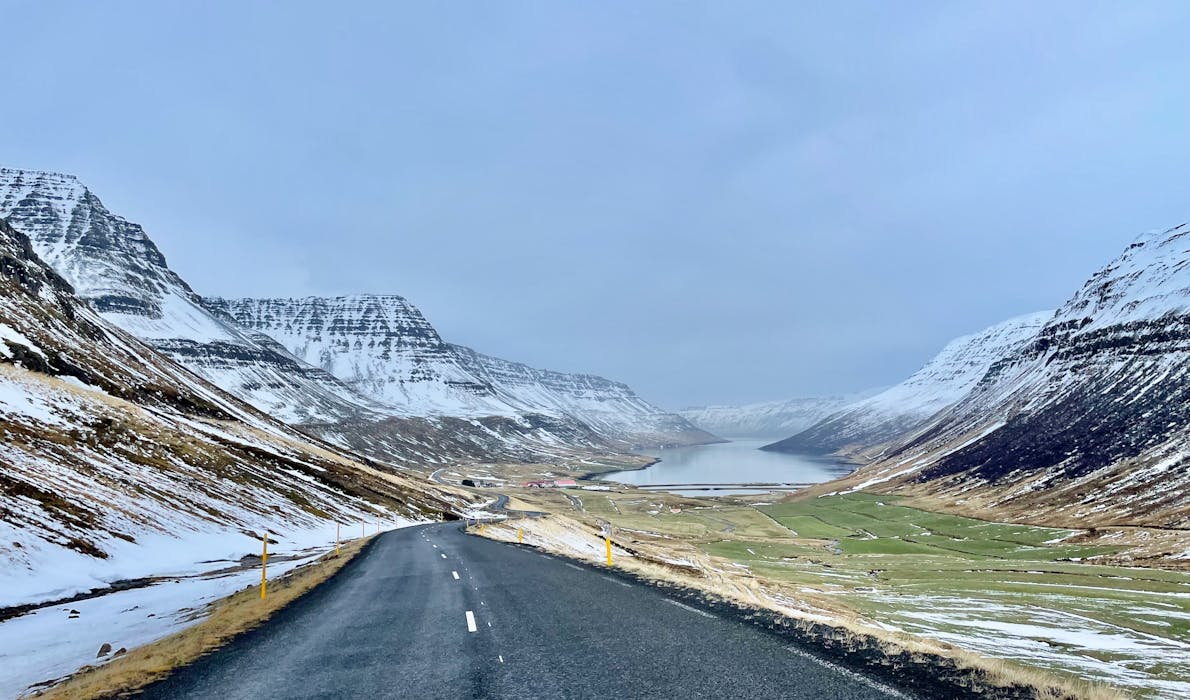 A narrow fjord with snow-capped mountains