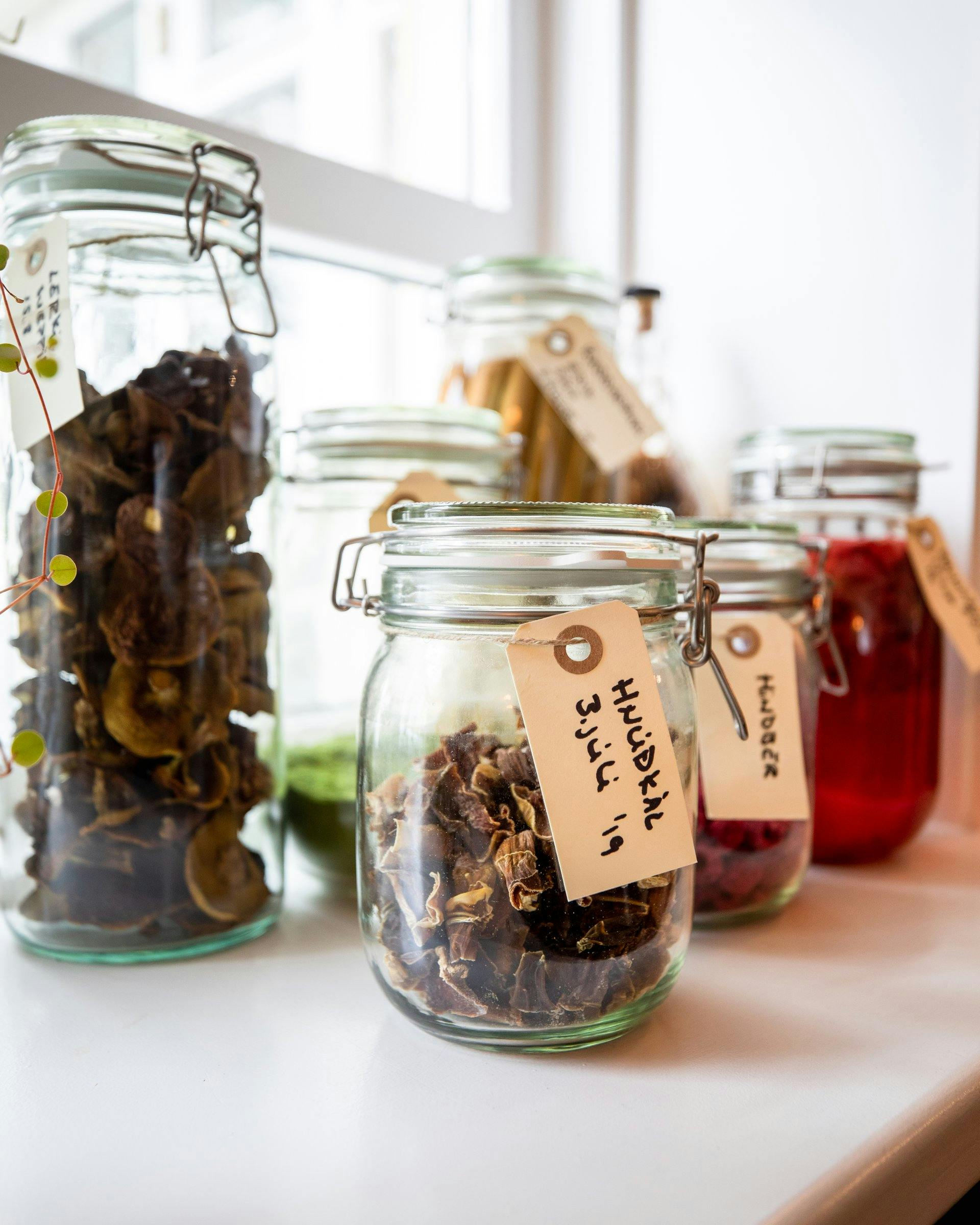 Preserving jars with dried fruit and vegetables on a window sill