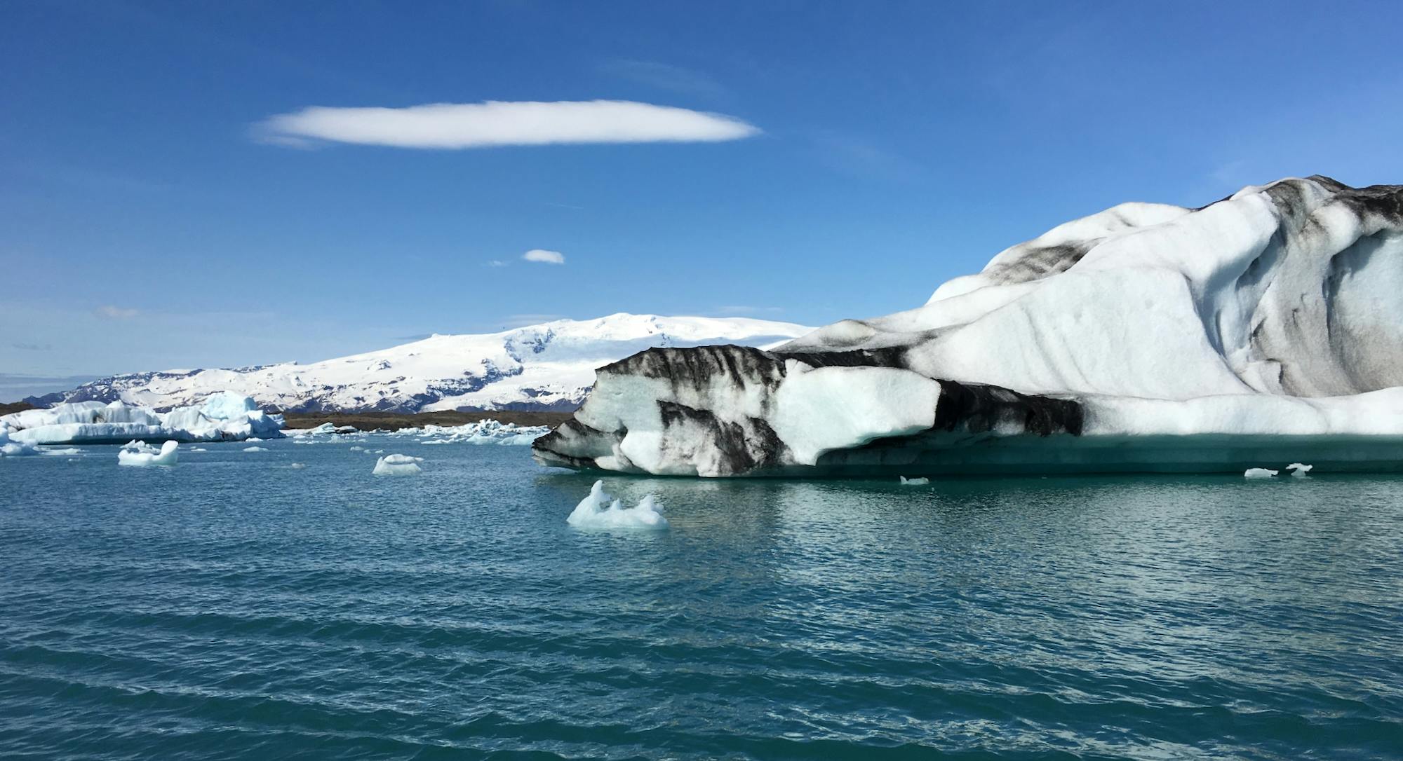 Icebergs with black stripes on a lake