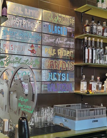 A wall-mounted table that displays the beer selection at Microbrewery