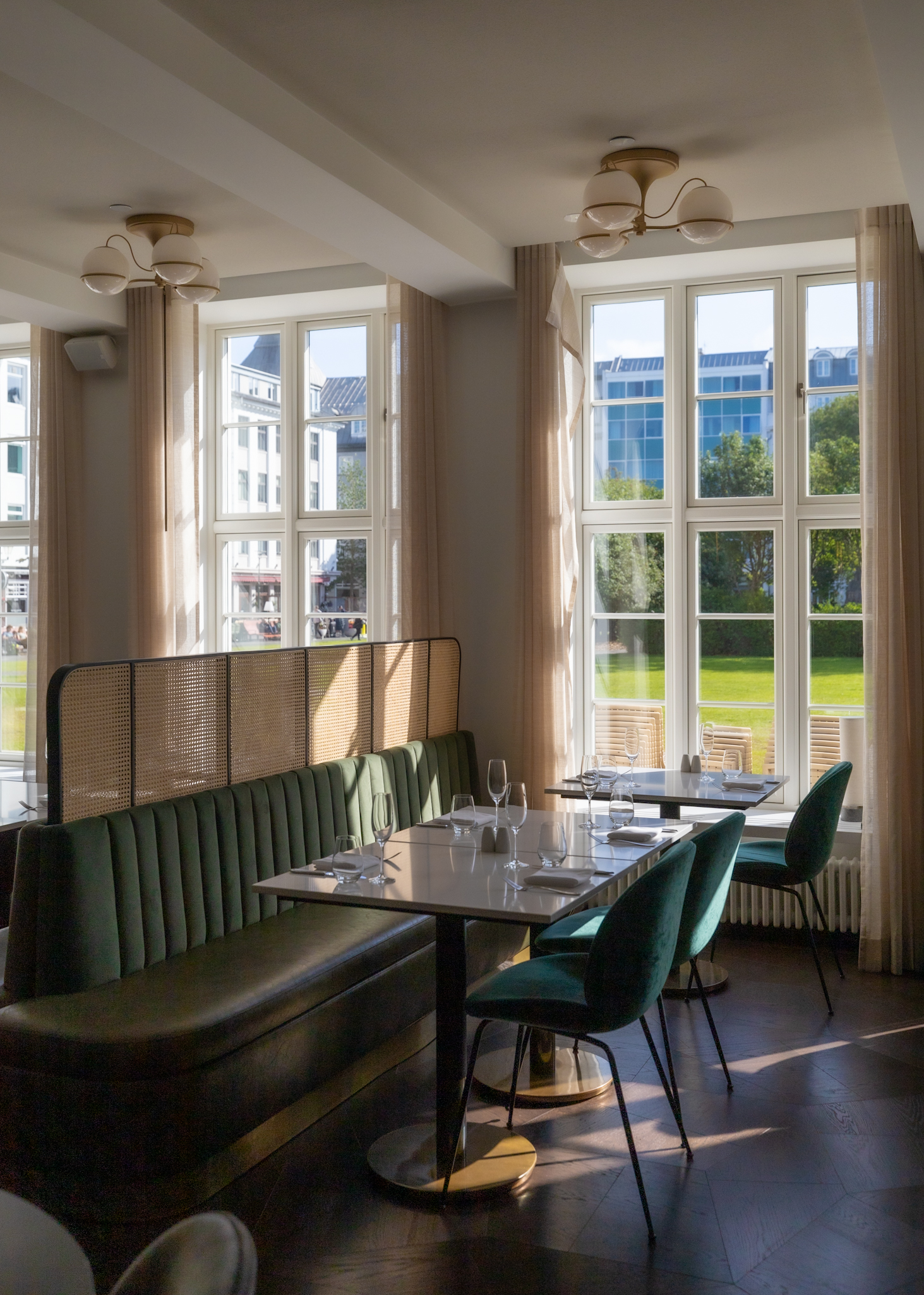 Tables and green booths at the charming restaurant Hjá Jóni in Reykjavik