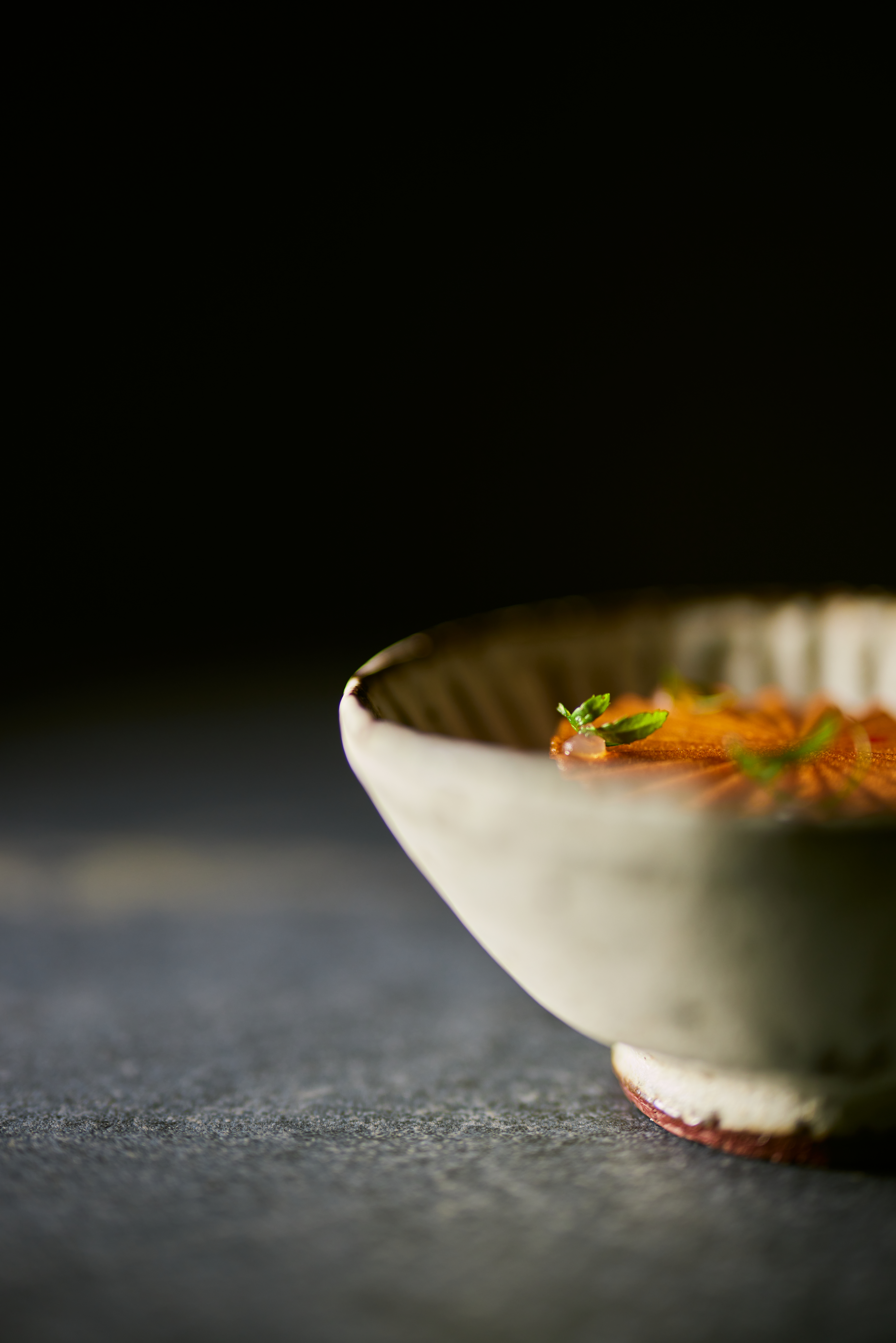 Close-up of a dish from Dill restaurant featuring bite-sized circular orange slices, presented in a white bowl