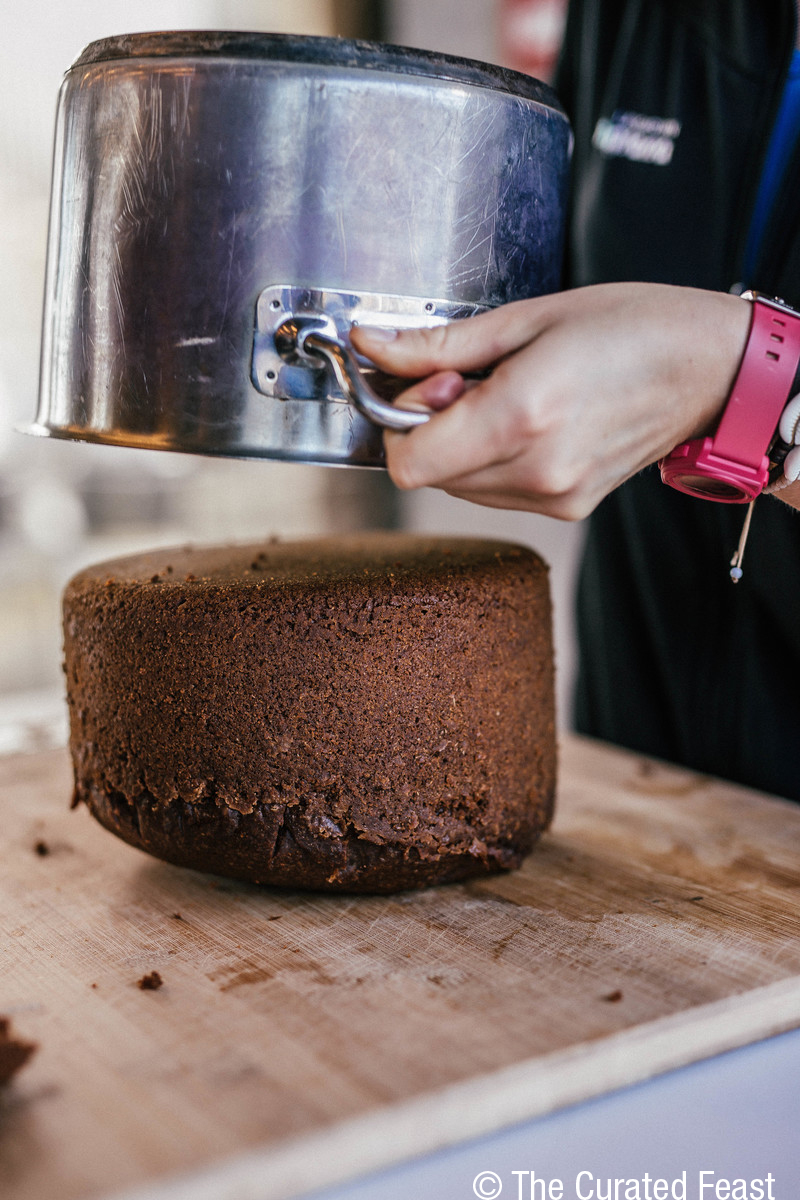 A freshly baked loaf of rye bread being lifted from a pot at Laugarvatn Fontana’s geothermal bakery.