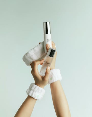 Hands holding BIOEFFECT skincare products, including EGF serum and essence, against a clean light background, highlighting Icelandic biotechnology based skincare.