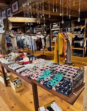 Gallerí Koltra displaying handmade Icelandic crafts, including knitted textiles, small gifts, and locally made decorative items inside a rustic wooden interior.