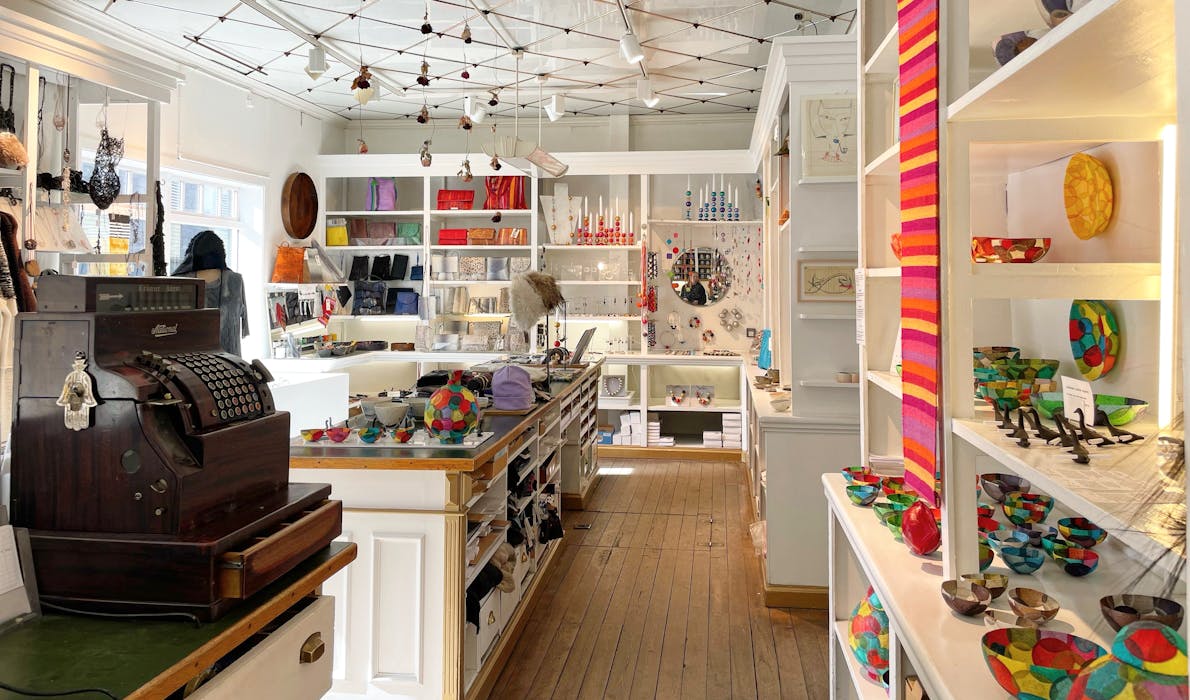 Interior of Kirsuberjatréð design shop in Reykjavík, showcasing Icelandic fashion, jewellery, textiles, ceramics, and handcrafted accessories displayed on shelves and tables.