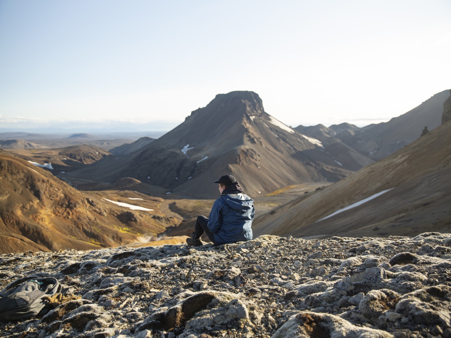 A person sitting on a mountain top in Iceland
