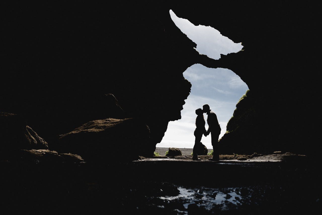 A couple kissing in Hjörleifshöfði also known as Yoda Cave