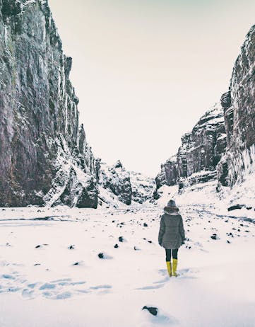 Woman walking in a ravine in snow
