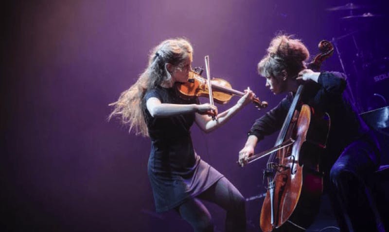 Two women playing violin