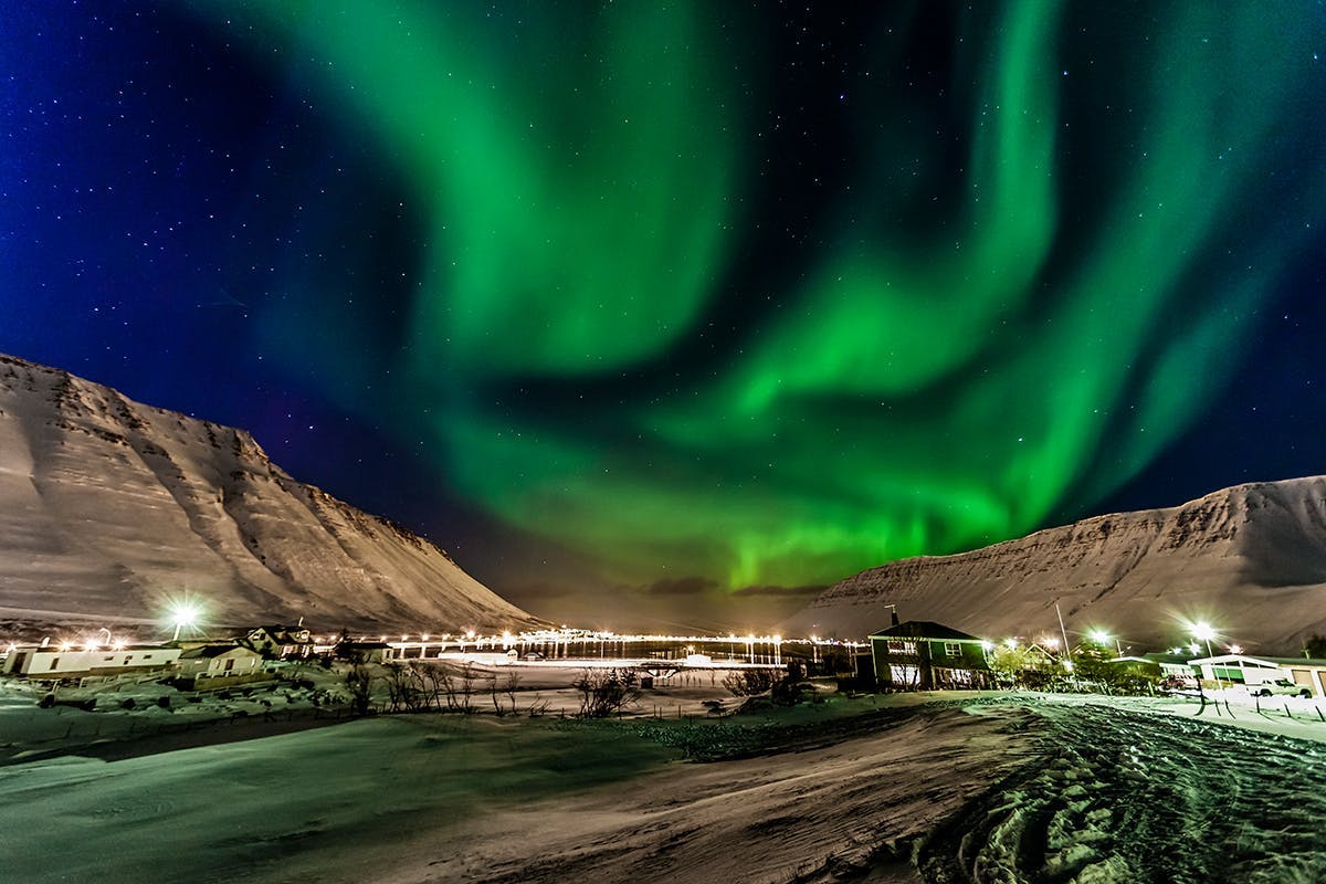 Isafjordur town bathed in Northern lights