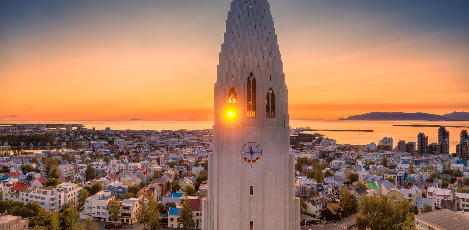 Midnight sun shining through the clocktower of Hallgrimskirkja Church in Reykjavik