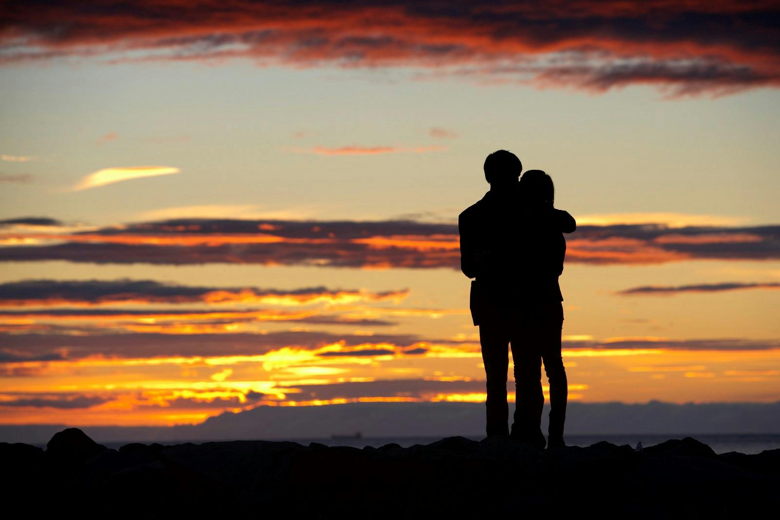 a couple kissing by the Icelandic sunset