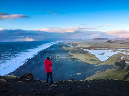 Man looking over Black beach in South Iceland