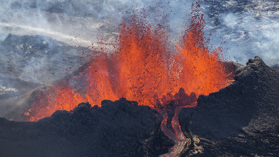Fire fountains rising from a volcanic crater