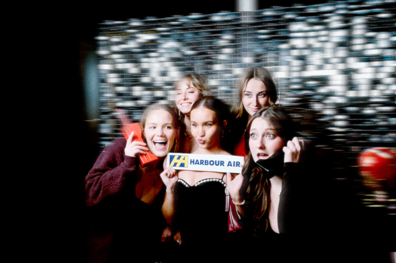 A group of colleagues posing in front of the PhotoBooth