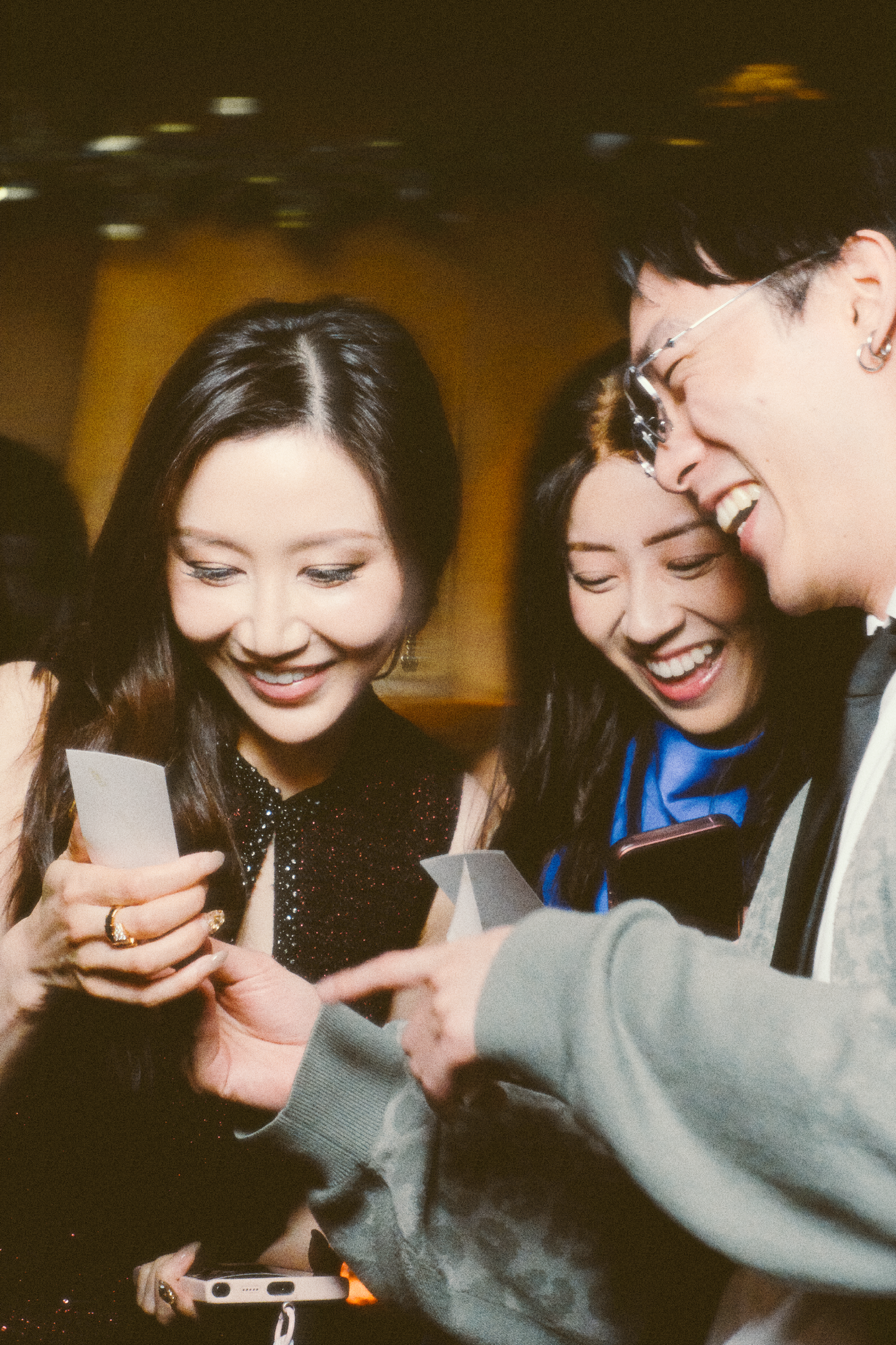 Friends or family discovering their photos with smiles