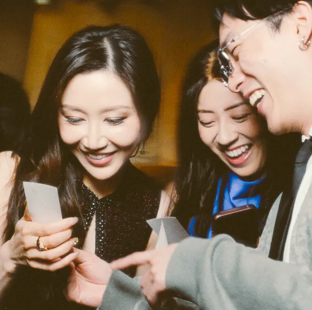 Friends or family discovering their photos with smiles