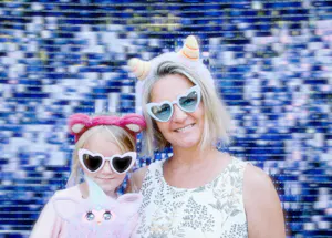 A happy family moment captured in a photo against a sparkling blue background