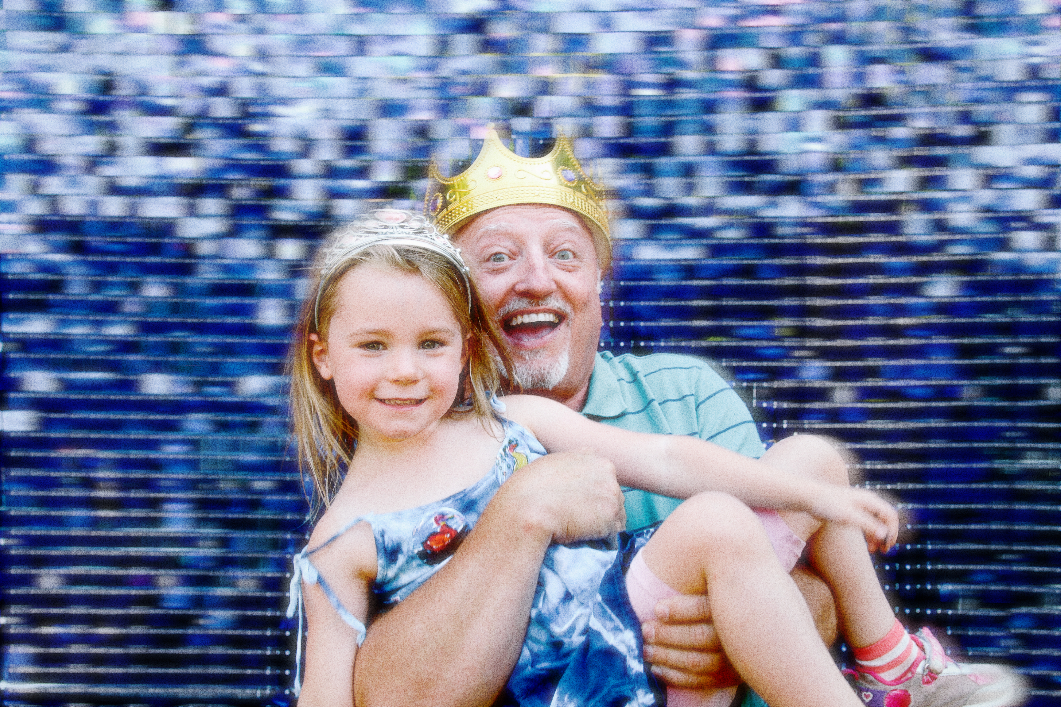 A grandfather holding his granddaughter in his arms for the photo