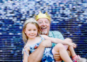 A grandfather holding his granddaughter in his arms for the photo