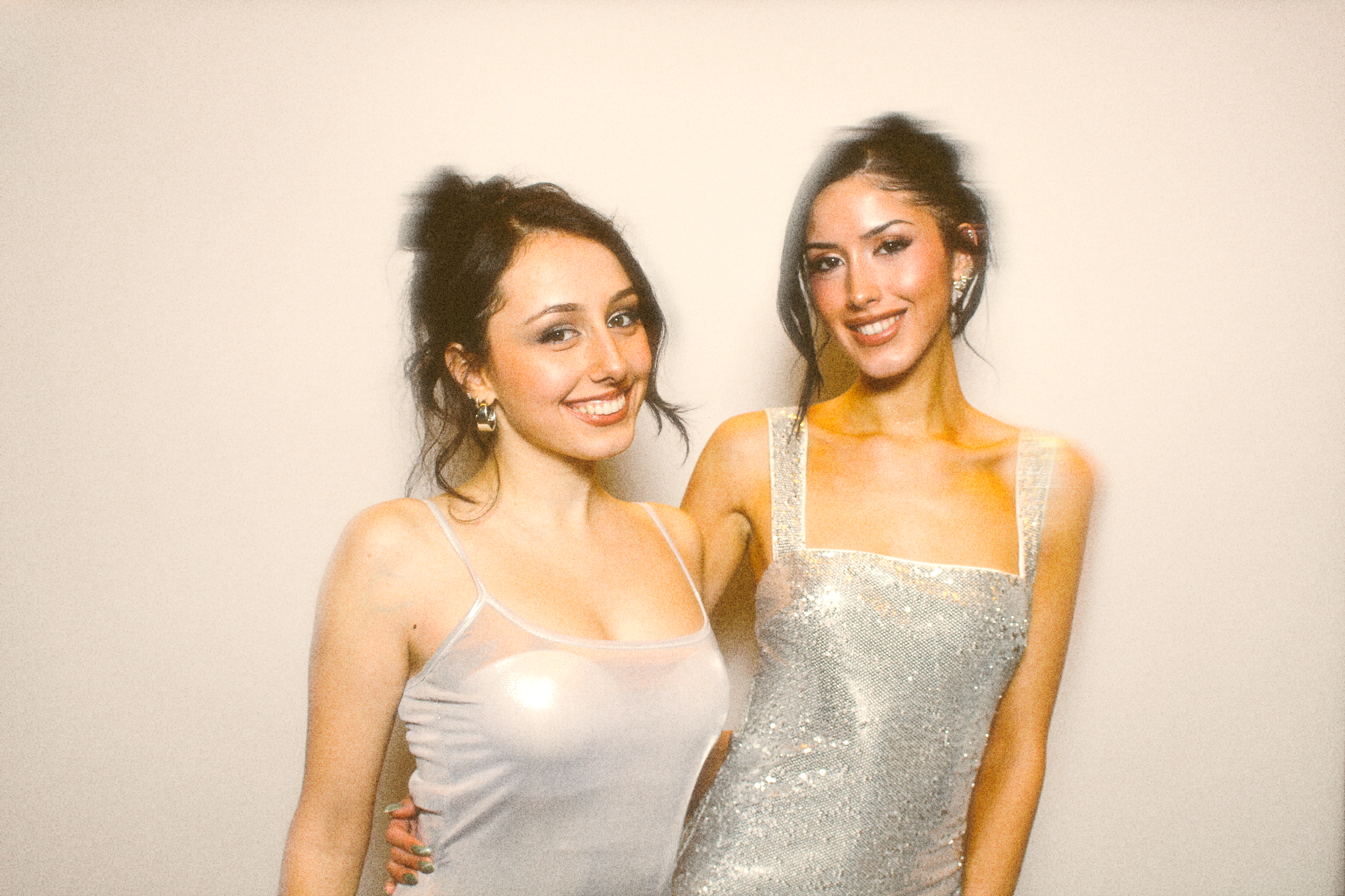 2 best friends in pretty dresses posing for a private party