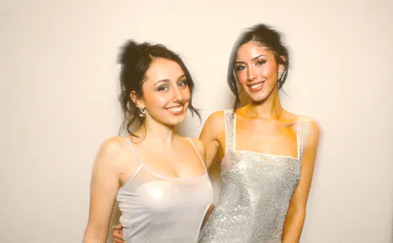 2 best friends in pretty dresses posing for a private party