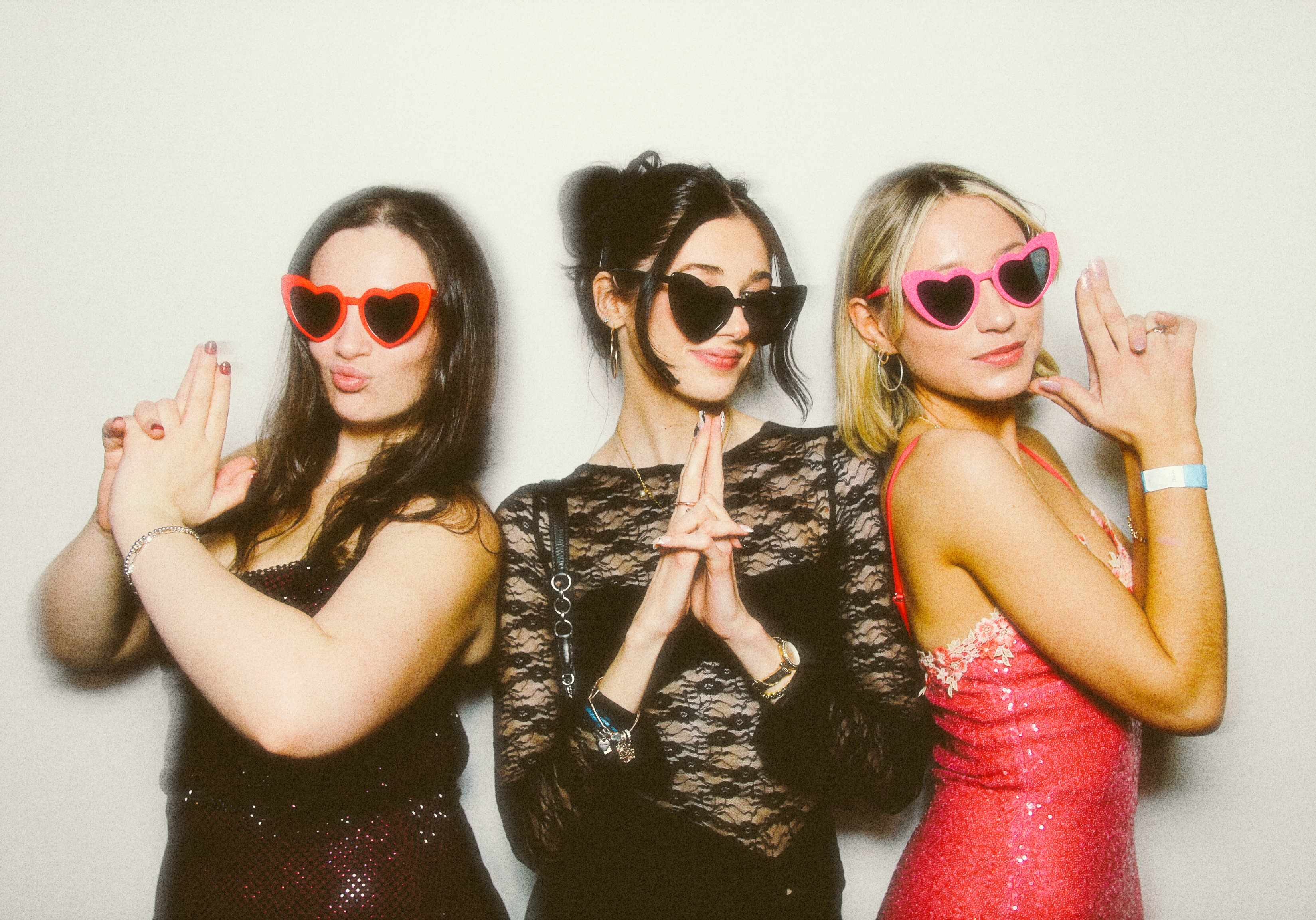 3 friends posing in James Bond style for a private party